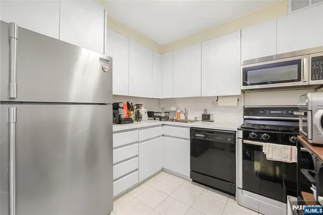 a kitchen with a refrigerator stove and microwave