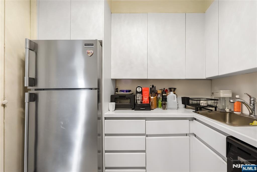2000 Linwood Avenue, Unit 5L Fort Lee, NJ 07024 - Photo 9 of 26 a kitchen with a refrigerator and cabinets