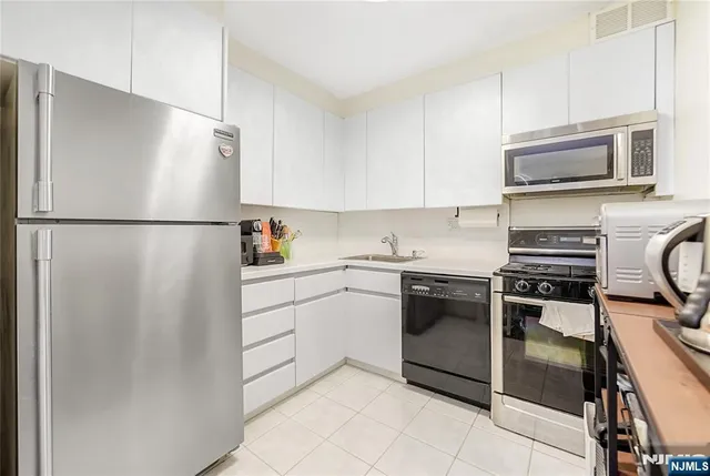 a white refrigerator freezer and a stove in a kitchen