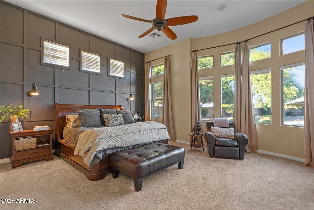 6427 South Magic Court Gilbert, AZ 85298 - Photo 12 of 71 a spacious bedroom with a bed couch and large windows