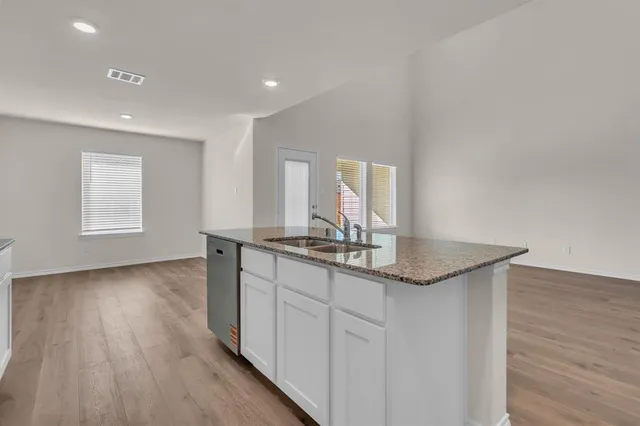 a hallway with sink and mirror