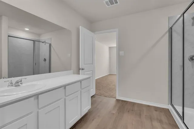 a spacious bathroom with a granite countertop sink mirror and double