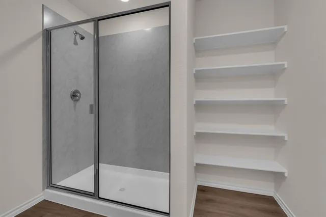 a bathroom with a glass shower door