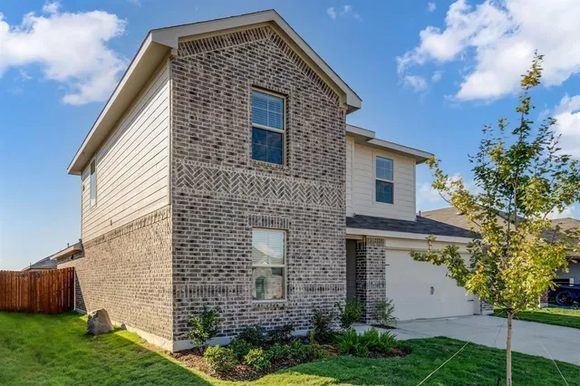 a front view of house with a garden