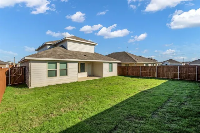 a view of a garden with a wooden fence