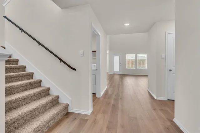 a view of an entryway with wooden floor