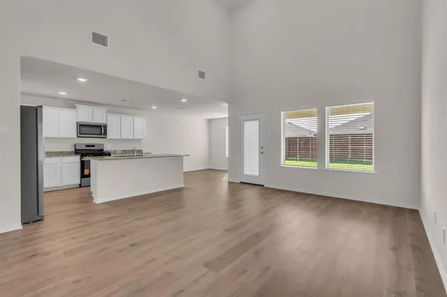 a view of kitchen with wooden floor and windows