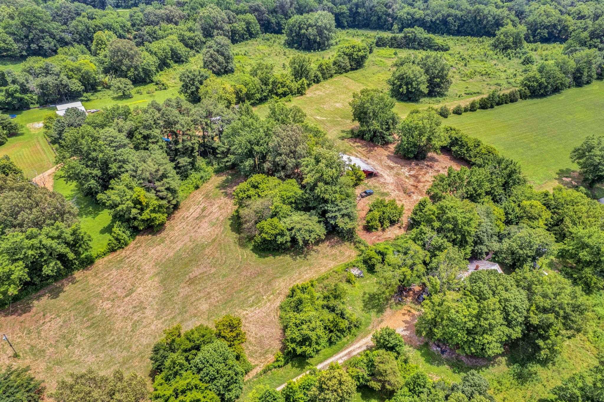 0 Holly Grove Road Covington, TN 38019 - Photo 8 of 11 an aerial view of a houses with a yard and lake