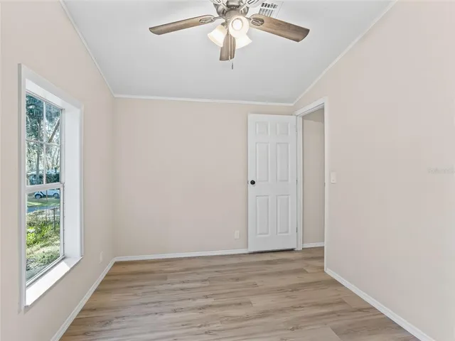 wooden floor in an empty room with a window