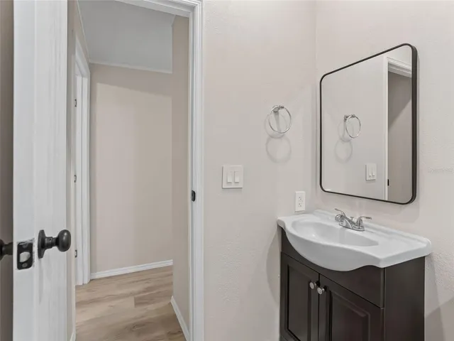 a bathroom with a sink vanity and a mirror