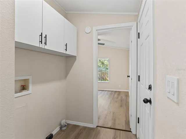 a view of a white house with a yard