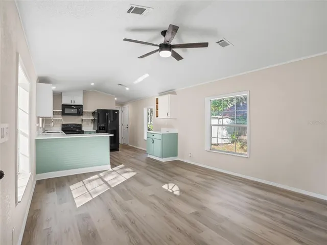 a view of kitchen with window and wooden floor