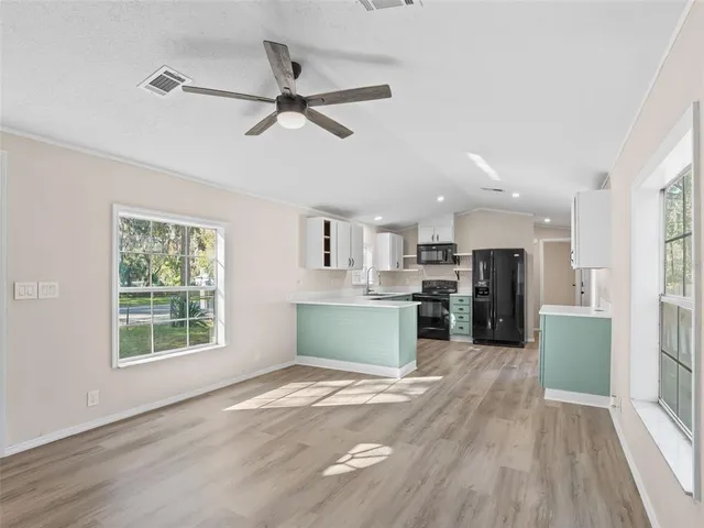 a view of kitchen with cabinets and wooden floor
