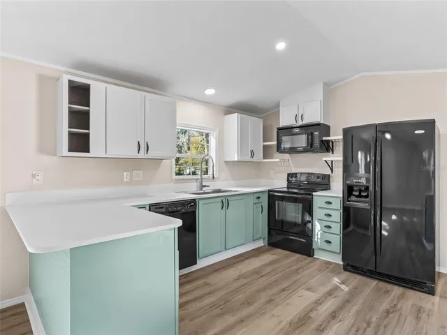 a kitchen with a sink stove and refrigerator