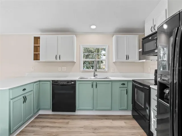 a kitchen with a sink stove and refrigerator