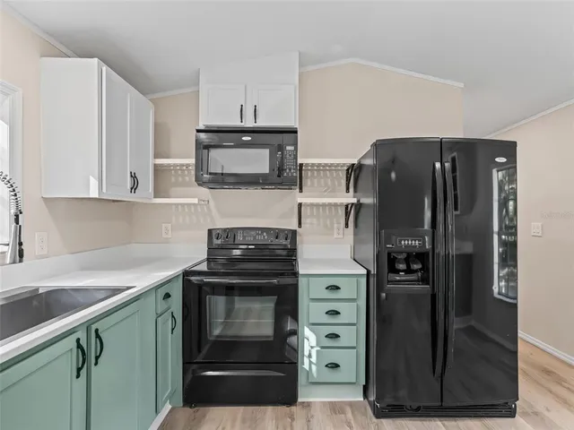 a kitchen with stainless steel appliances and refrigerator