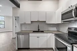 a kitchen with stainless steel appliances granite countertop a sink and a stove
