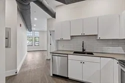 a kitchen with stainless steel appliances granite countertop a sink and cabinets