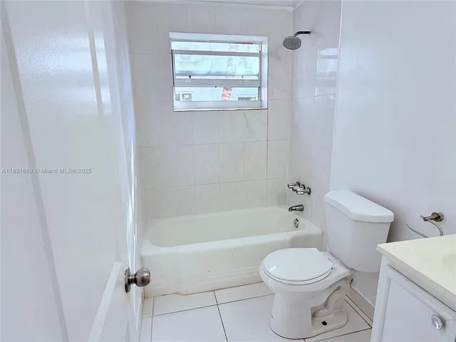 a bathroom with a toilet and a bath tub