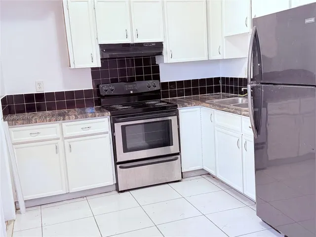 a kitchen with appliances and cabinets