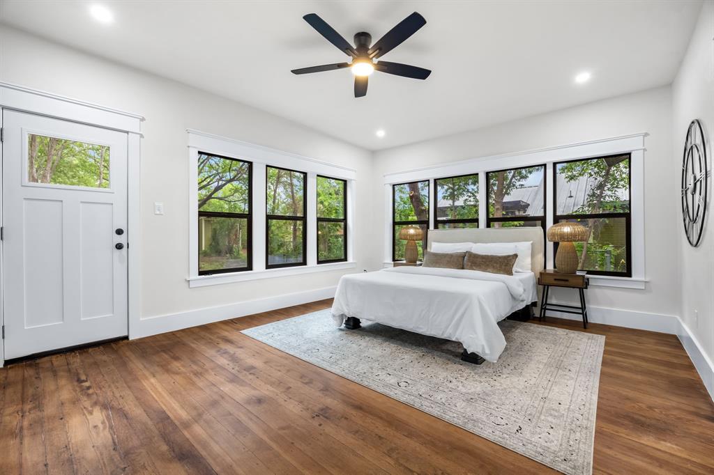 1014 Bolivar Street Denton, TX 76201 - Photo 19 of 36 a spacious bedroom with a large bed and a large window
