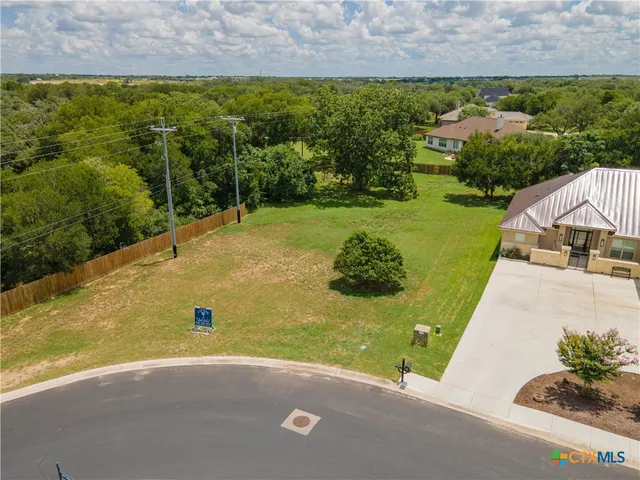 an aerial view of a house with a yard