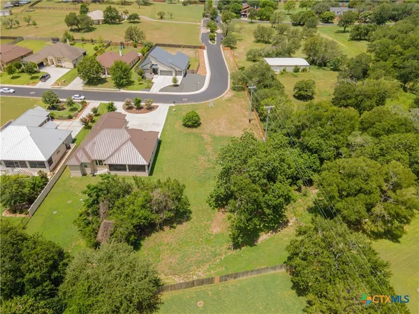 an aerial view of a residential houses with outdoor space