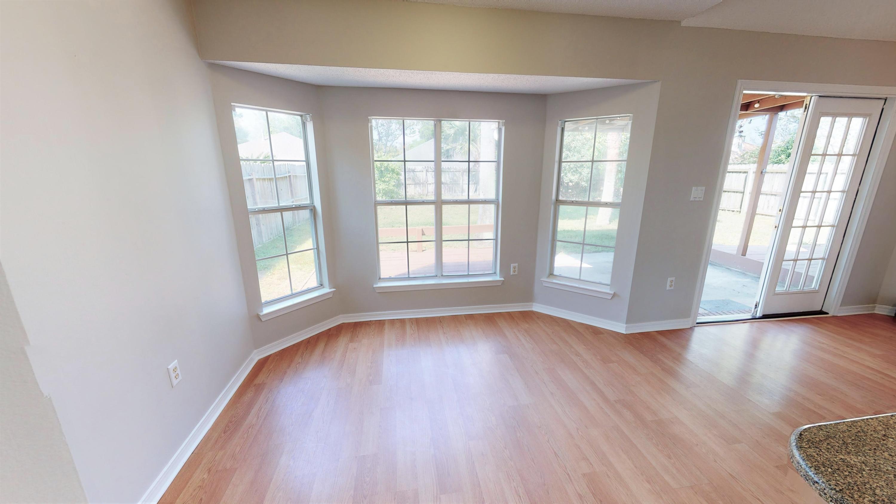 3621 Goldsbys Way Destin, FL 32541 - Photo 14 of 38 an empty room with wooden floor and windows
