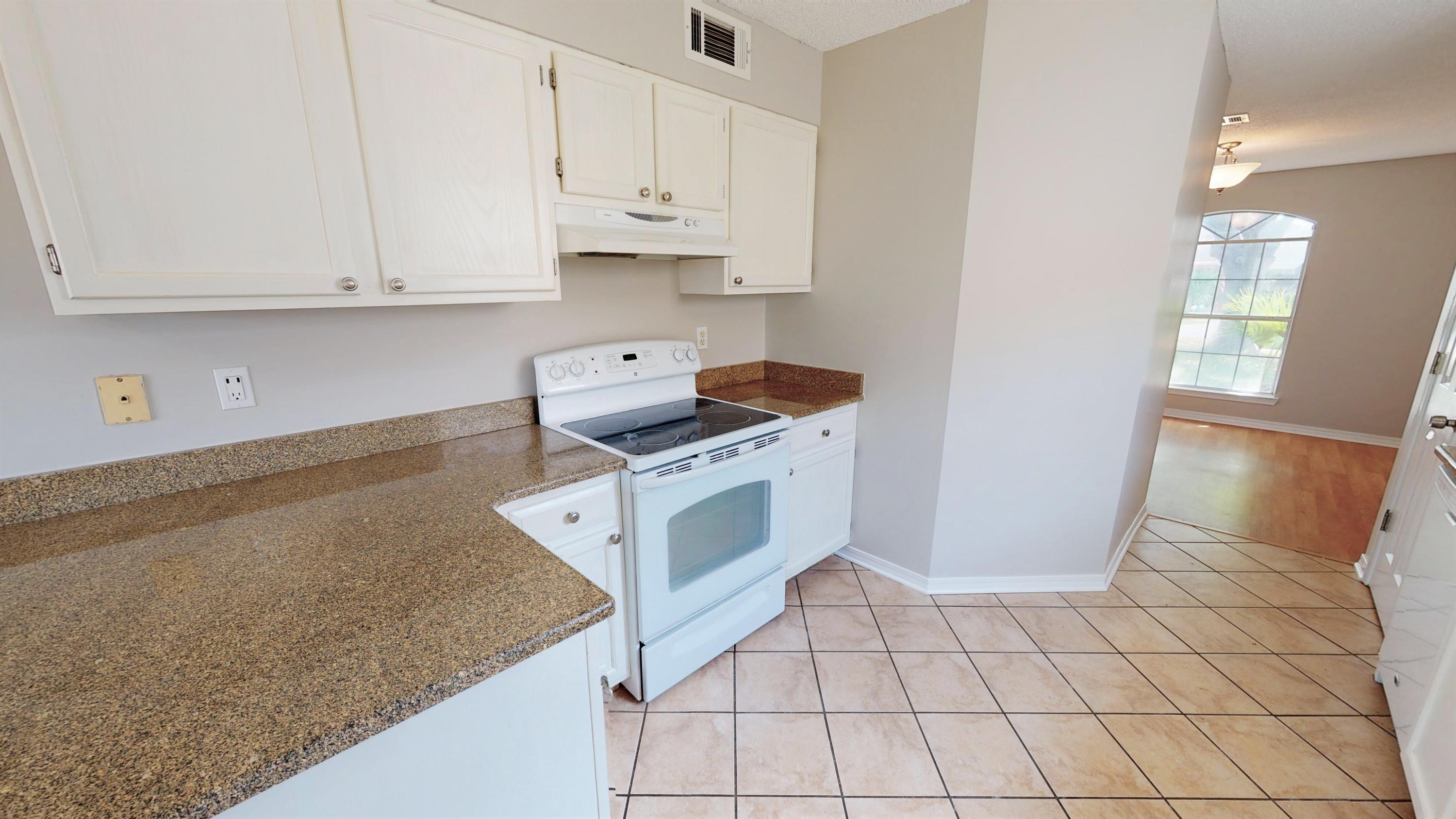 3621 Goldsbys Way Destin, FL 32541 - Photo 17 of 38 a kitchen with white cabinets and white appliances