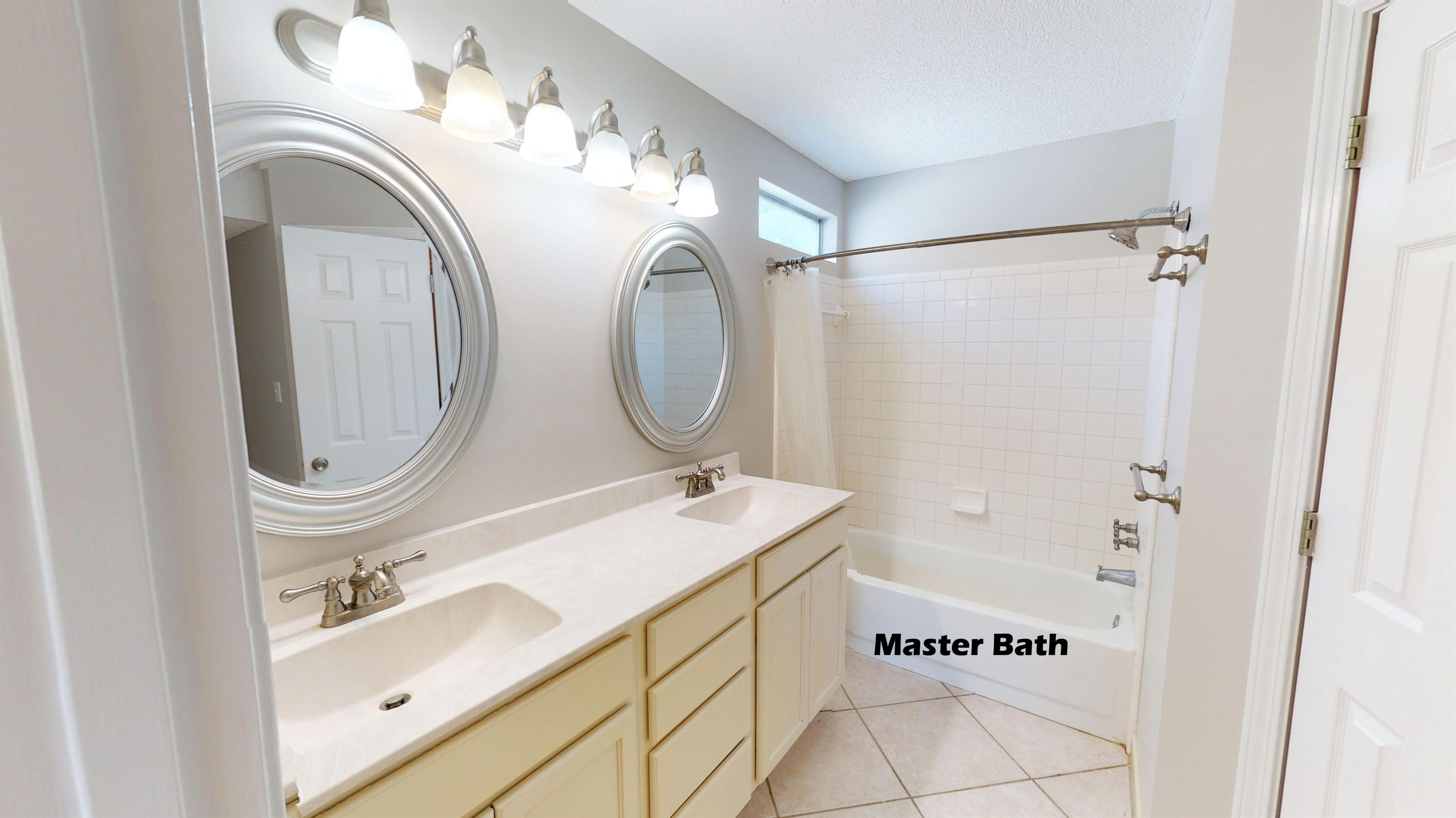 3621 Goldsbys Way Destin, FL 32541 - Photo 22 of 38 a bathroom with a sink a mirror and a shower