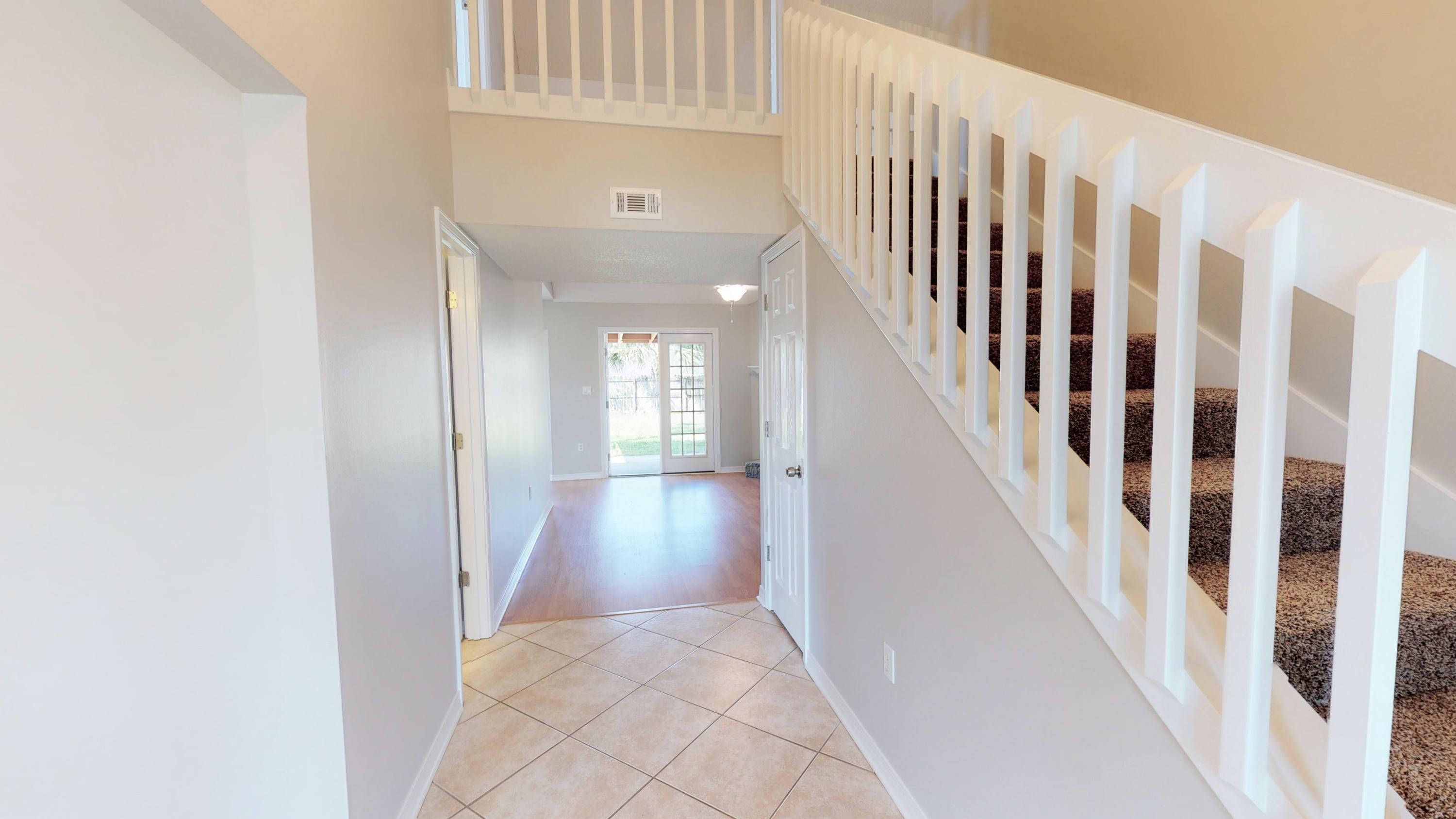 3621 Goldsbys Way Destin, FL 32541 - Photo 9 of 38 a view of a hallway with wooden floor and staircase