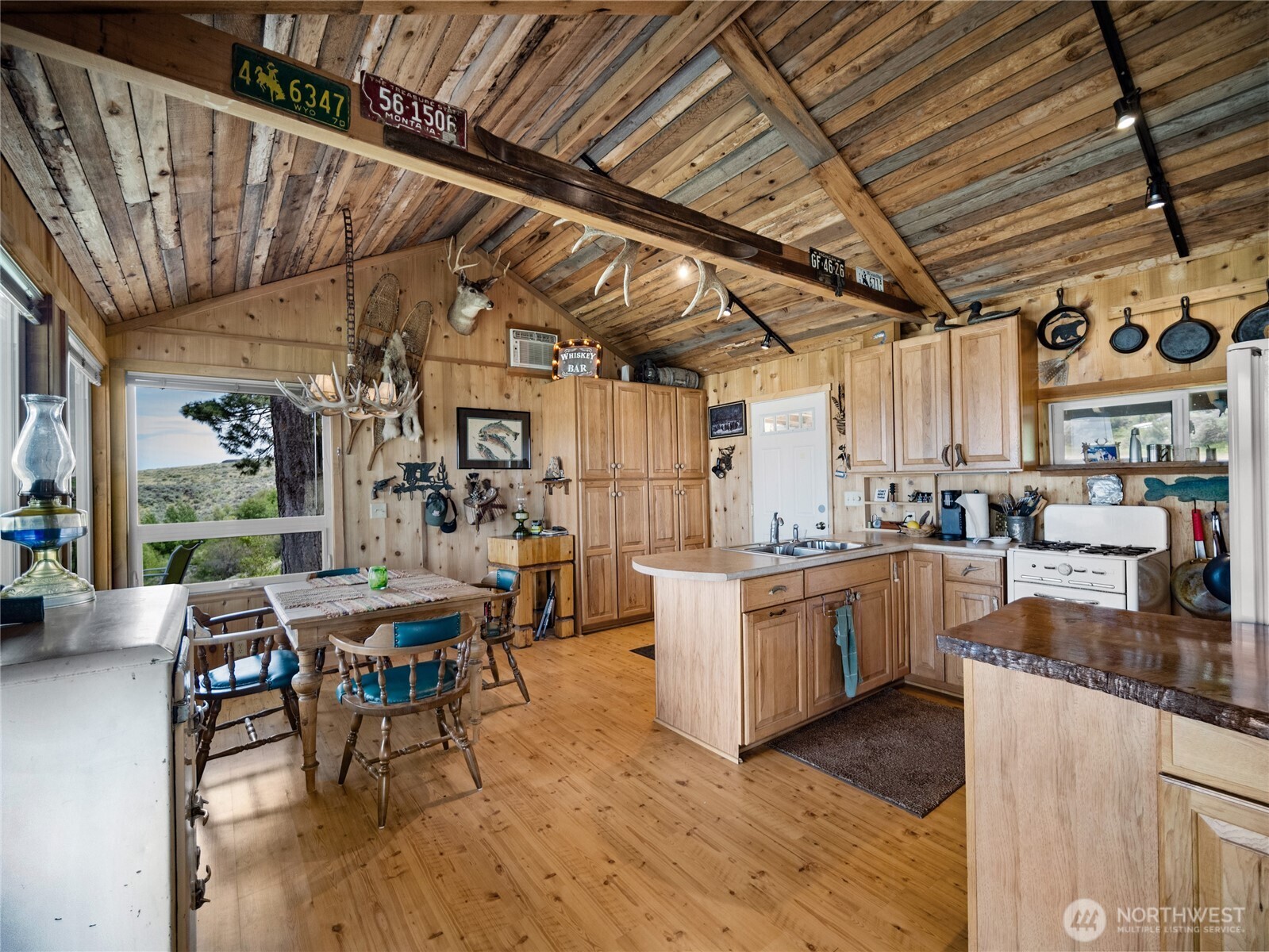 0 Q Road Northeast Mansfield, WA 98830 - Photo 17 of 29 a open kitchen with stainless steel appliances granite countertop a stove a sink dishwasher and cabinets with wooden floor