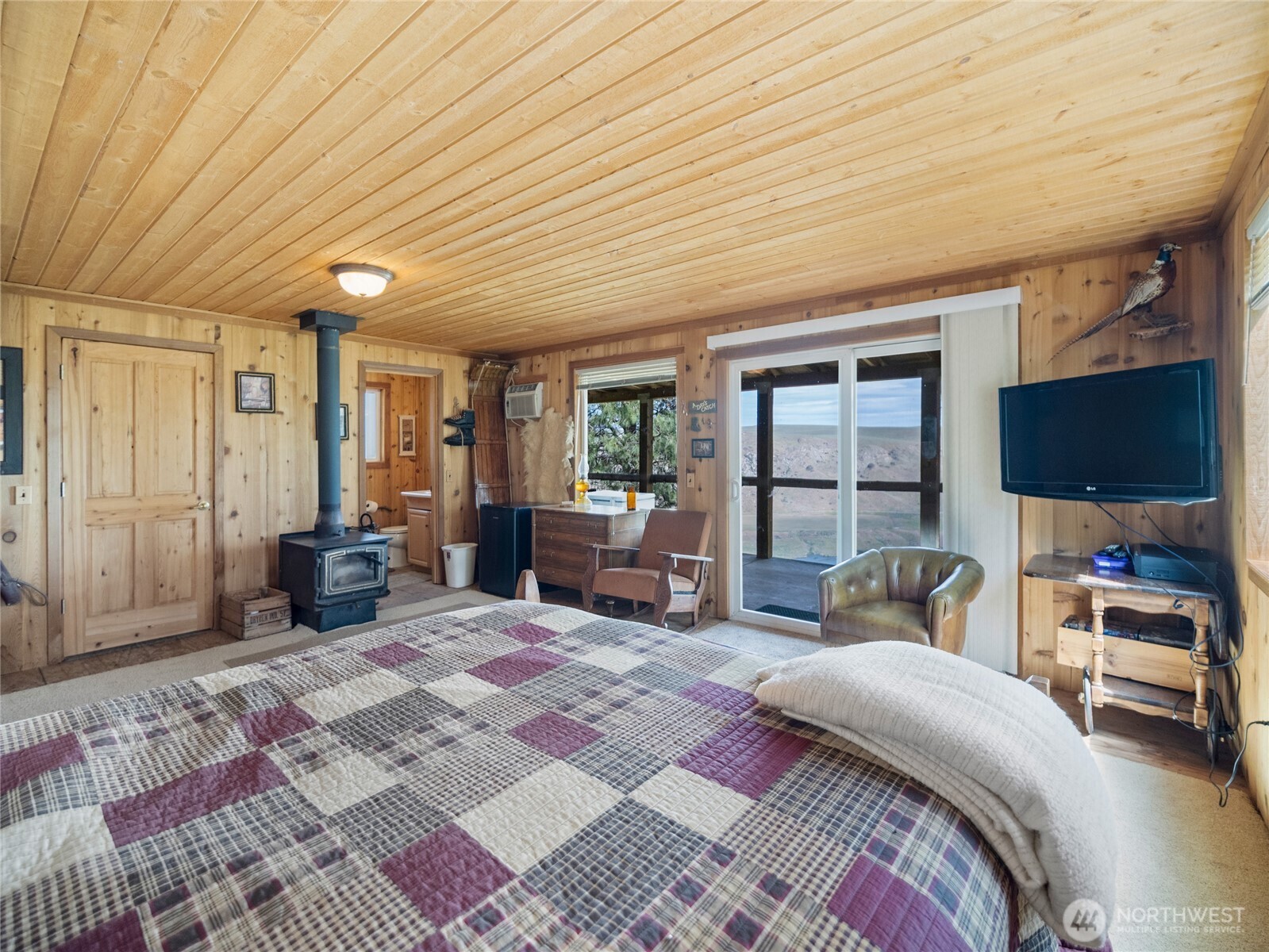 0 Q Road Northeast Mansfield, WA 98830 - Photo 23 of 29 a bedroom with furniture large window and flat screen tv
