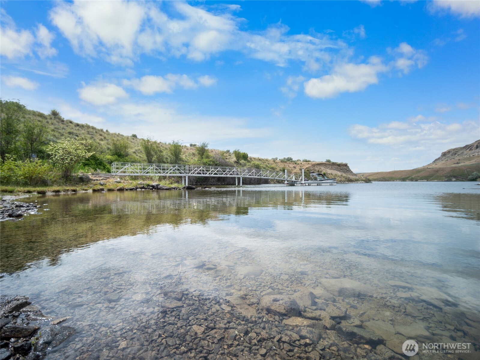 0 Q Road Northeast Mansfield, WA 98830 - Photo 25 of 29 a view of a lake with houses in the back