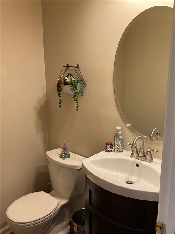 2430 Jakin Way Suwanee, GA 30024 - Photo 11 of 55 a bathroom with a sink a mirror and a toilet