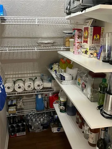 a kitchen with granite countertop lots of counter top space and wooden floor