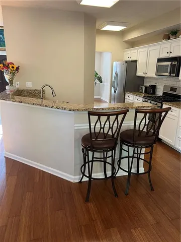 a living room with furniture a fireplace and a chandelier
