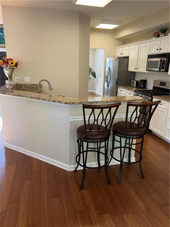 2430 Jakin Way Suwanee, GA 30024 - Photo 16 of 55 a view of a dining room with furniture and wooden floor