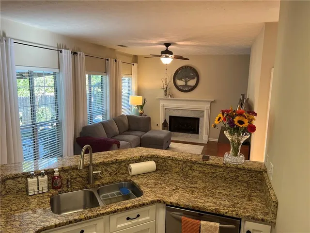 a living room with furniture and a floor to ceiling window