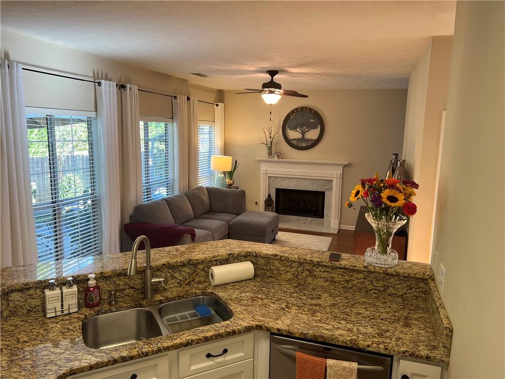 2430 Jakin Way Suwanee, GA 30024 - Photo 24 of 55 a living room with furniture and a fireplace