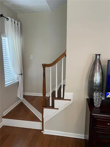 a bed sitting in a bedroom next to a lamp