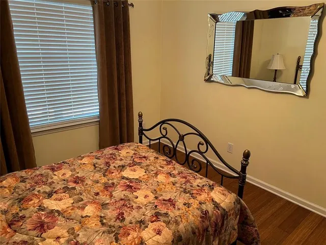 a view of a hallway with wooden floor and furniture