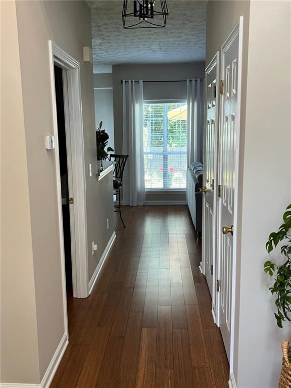 2430 Jakin Way Suwanee, GA 30024 - Photo 4 of 55 a view of a hallway with wooden floor and staircase
