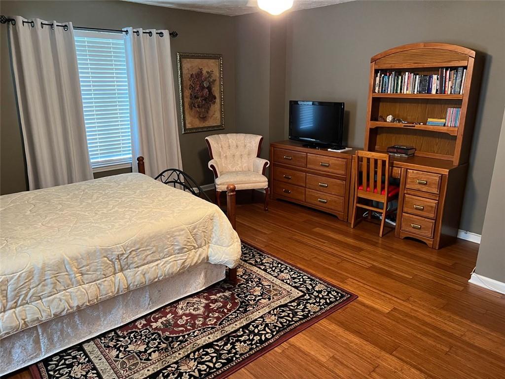 2430 Jakin Way Suwanee, GA 30024 - Photo 45 of 55 a bedroom with a bed and wooden floor