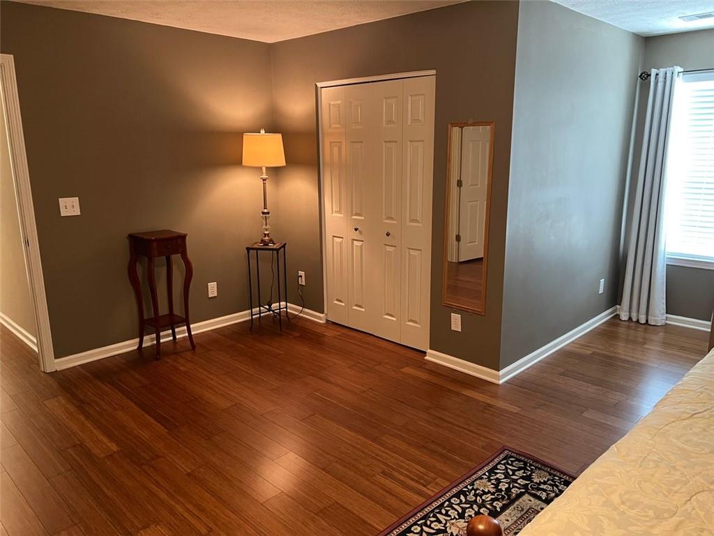 2430 Jakin Way Suwanee, GA 30024 - Photo 46 of 55 an empty room with wooden floor and a window