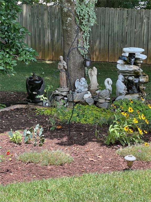 2430 Jakin Way Suwanee, GA 30024 - Photo 51 of 55 a backyard of a house with table and chairs