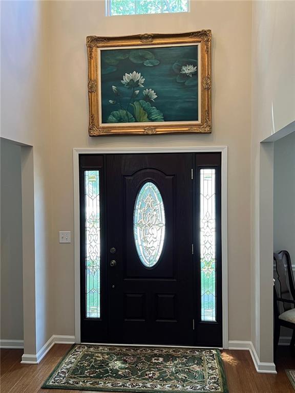 2430 Jakin Way Suwanee, GA 30024 - Photo 6 of 55 a view of a wooden door with a clock on the wall