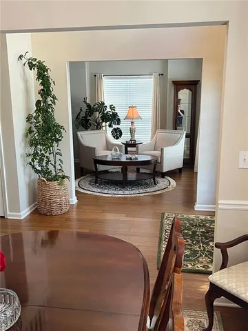 a living room with furniture and flowers