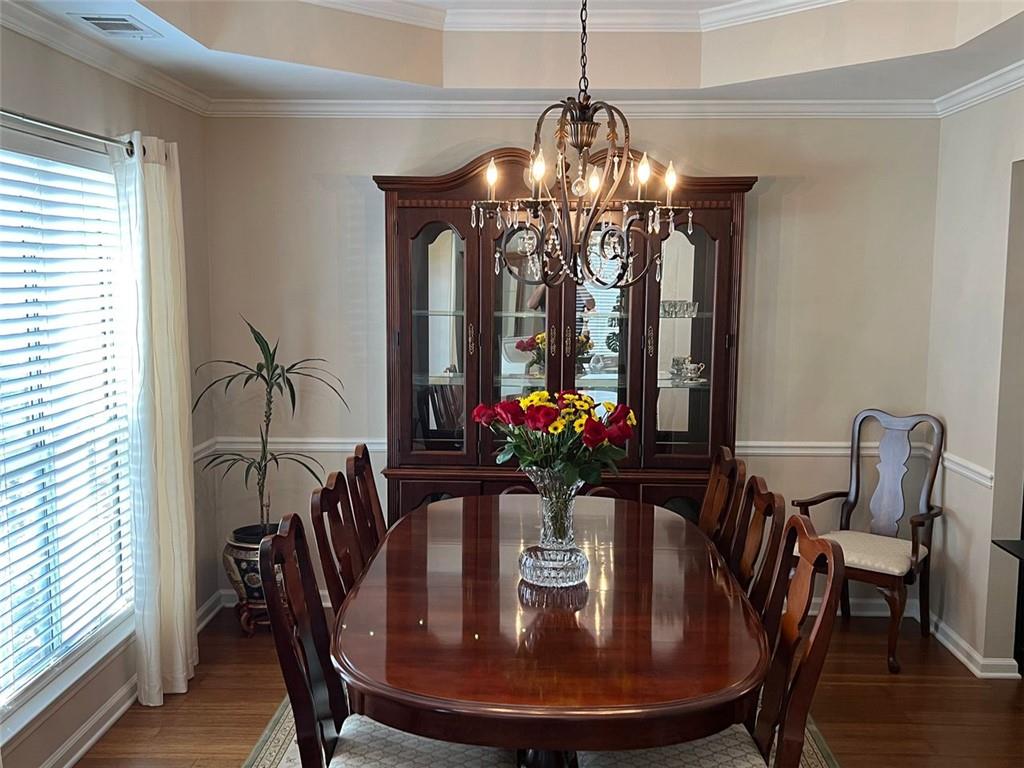 2430 Jakin Way Suwanee, GA 30024 - Photo 10 of 55 a view of a dining room with furniture window and wooden floor