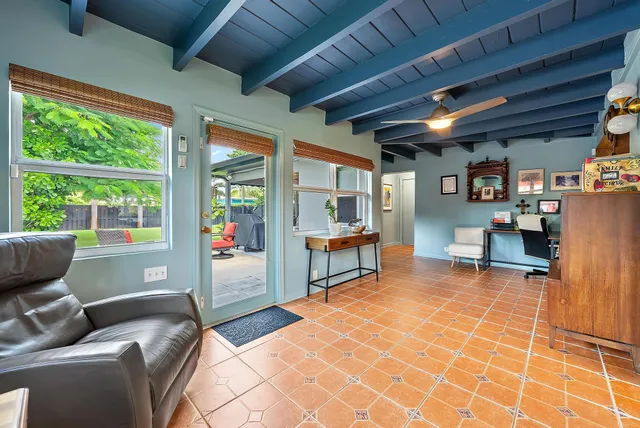 a living room with furniture a dining table and a large window